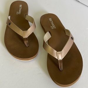 Gold flip flop shoes
